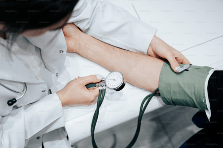 enfermeira medindo a pressão no braço de um paciente
